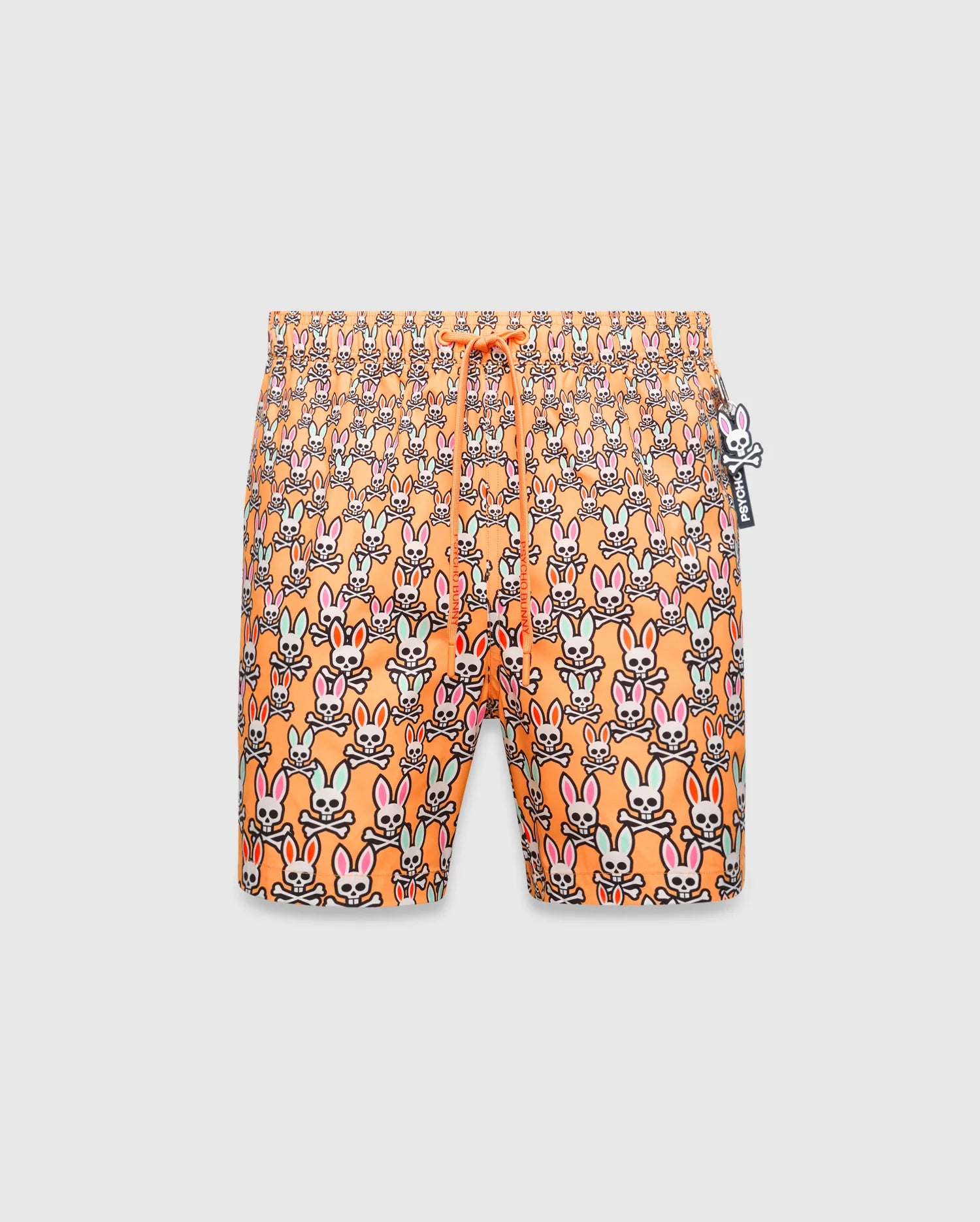 Mens Byron Swim Trunk 6, orange with an all-over multi-color Psycho Bunny skull pattern, drawstring waist, and a small Psycho Bunny logo charm.
