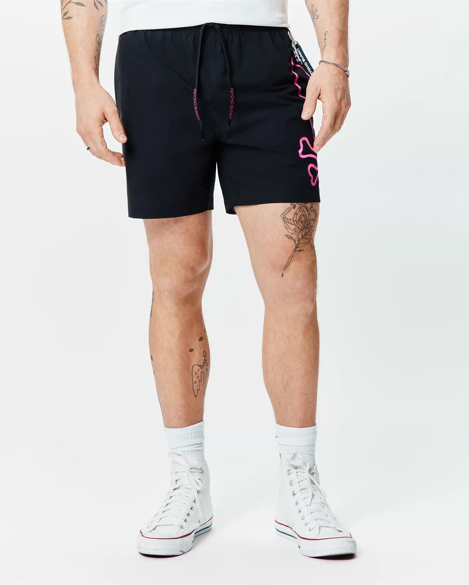 Mens Duncan Bunny Print Swim Trunk in black, featuring a large pink outline bunny skull graphic on the left leg, pink Psycho Bunny text on the drawstring, and side tape. Smooth fabric, classic fit.