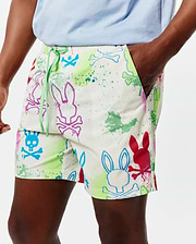 Mens Quintin All Over Print Swim Trunk in white, with a vibrant multicolor paint splatter and outlined Psycho Bunny skull logo pattern, featuring a relaxed fit and green drawstring with PSYCHO BUNNY text.