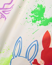 Mens Quintin All Over Print Swim Trunk, cream fabric with vibrant green, purple, blue, and red paint splatter print, featuring repeated Psycho Bunny skull outlines and solid shapes.