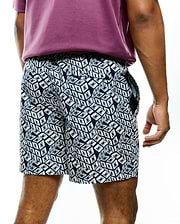 Mens Eddy All Over Print Swim Trunk in navy and white, featuring a relaxed fit, smooth quick-dry fabric, and an all-over geometric cube pattern with small Psycho Bunny skull logos.