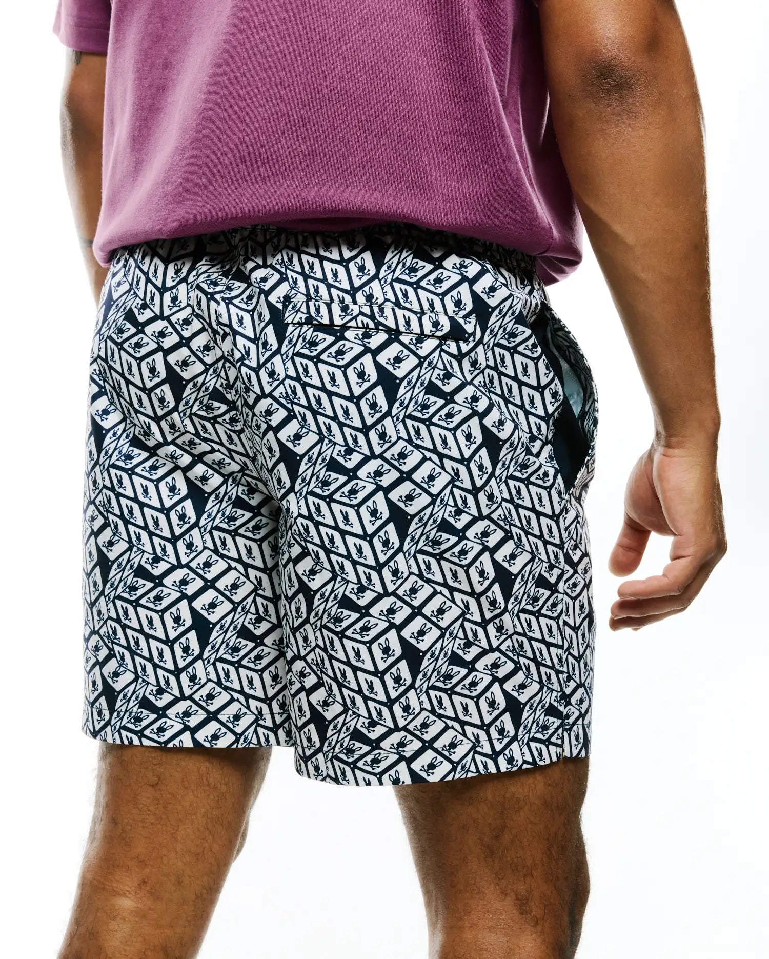 Mens Eddy All Over Print Swim Trunk in navy and white, featuring a relaxed fit, smooth quick-dry fabric, and an all-over geometric cube pattern with small Psycho Bunny skull logos.