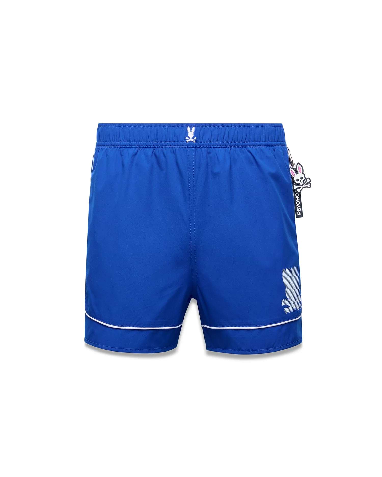 Mens Nathaniel Swim Trunk, royal blue, with white piping, small embroidered Psycho Bunny skull logo on left hip, large white striped graphic logo on right leg, and a black and pink Psycho Bunny tag.
