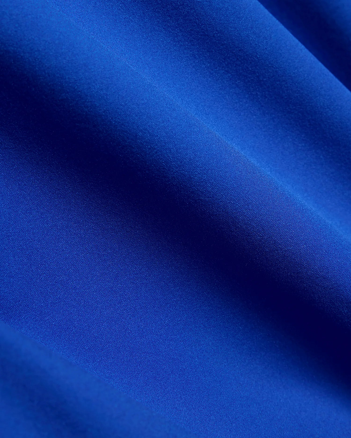 Vibrant royal blue Mens Nathaniel Swim Trunk, featuring a smooth, durable, finely woven fabric with a subtle, quick-drying texture, perfect for active wear.