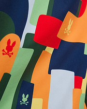 Mens Wes All Over Print Swim Trunk featuring a vibrant abstract pattern in navy, green, orange, red, and light grey, with scattered Psycho Bunny skull logos integrated into the smooth fabric.