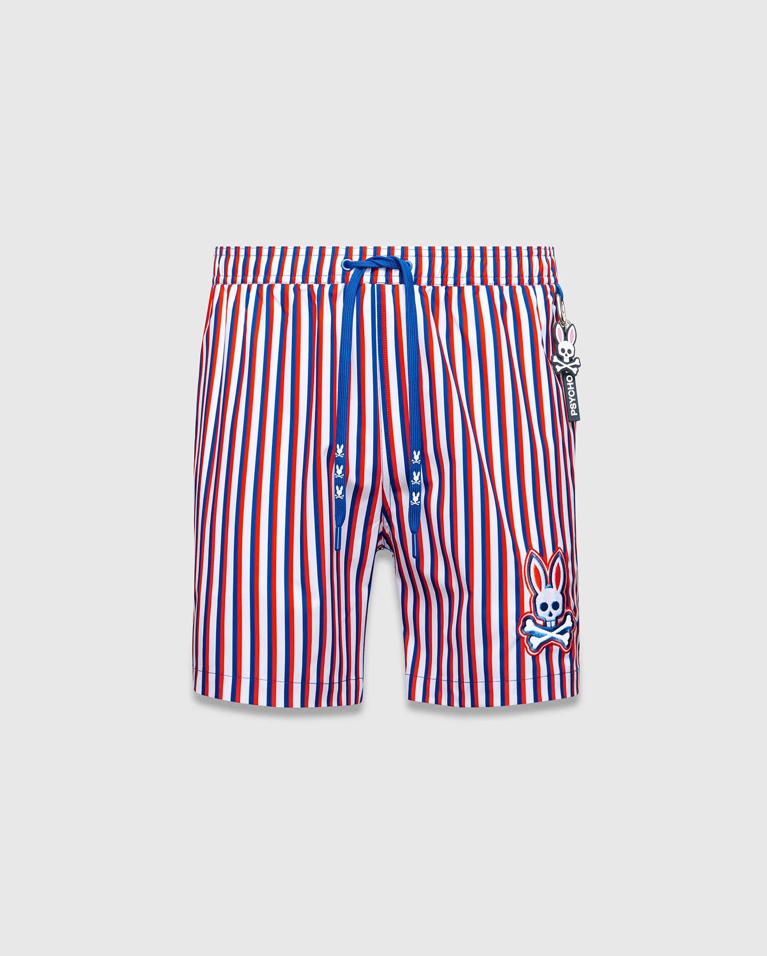 Mens John All Over Print Swim Trunk, red, white, blue vertical stripes, blue drawstring with mini bunny skulls, large embroidered Psycho Bunny skull logo on left leg, and Psycho Bunny tag.