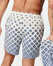Mens Tobias Swim Trunk in cream with a navy blue all-over geometric pattern featuring the small Psycho Bunny skull logo, classic fit, smooth quick-dry fabric, and a back pocket.