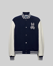 Mens Jacob Leather Bomber in navy with cream leather sleeves, featuring a large embroidered Psycho Bunny skull logo on the left chest, snap buttons, and white striped ribbed knit trim.
