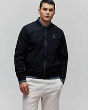 Black Mens Aldrin Bomber jacket, classic fit, featuring a full zip, teal and white striped ribbed collar and cuffs, and an embroidered light blue Psycho Bunny skull logo on the left chest.
