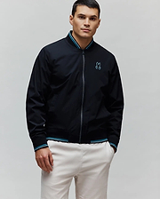 Black Mens Aldrin Bomber jacket, classic fit, featuring a full zip, teal and white striped ribbed collar and cuffs, and an embroidered light blue Psycho Bunny skull logo on the left chest.