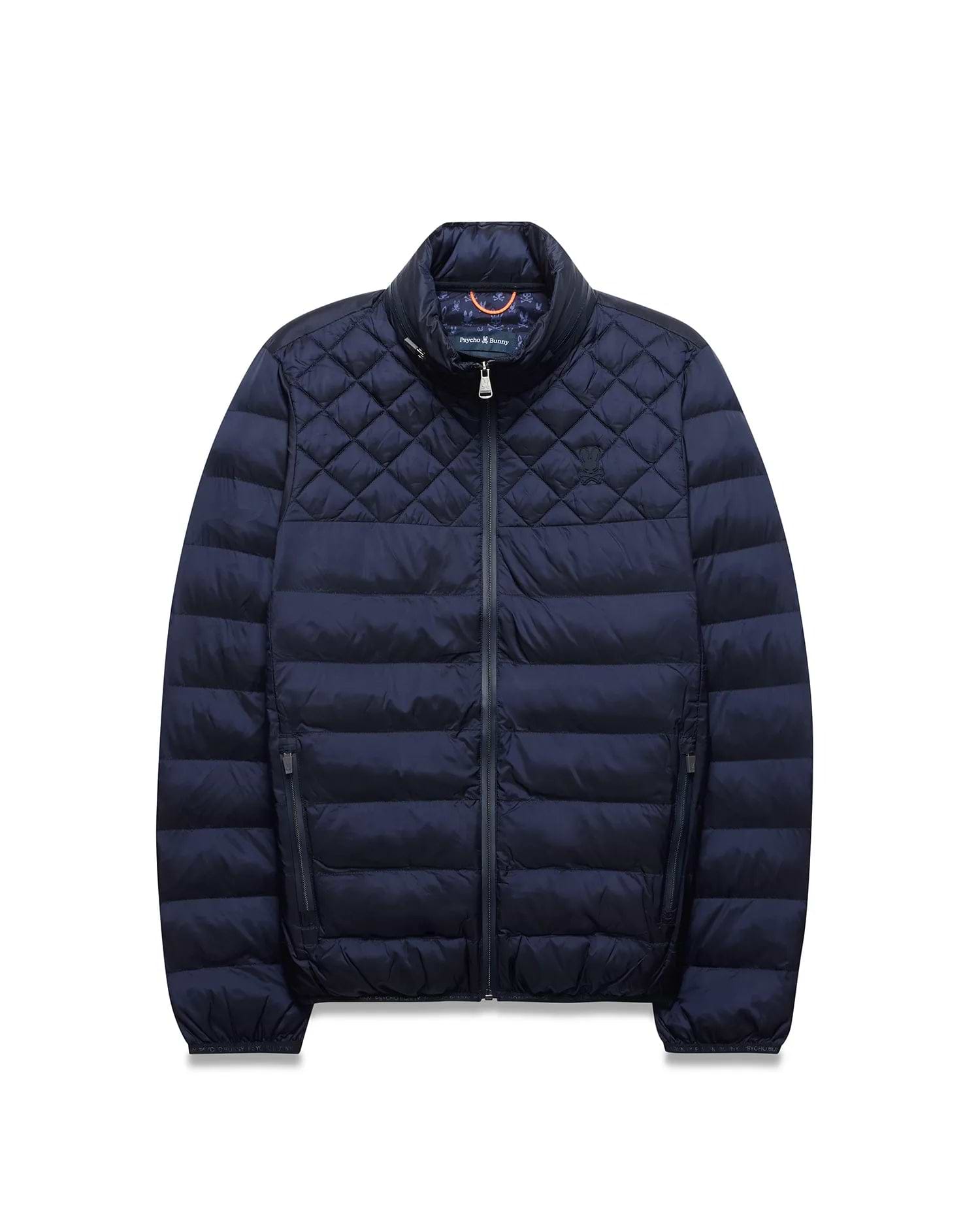 Navy Mens Emerik Puffer Jacket, quilted upper, horizontal baffles, stand collar, full zip, zippered pockets. Small embroidered Psycho Bunny skull on left chest, colorful patterned inner collar.