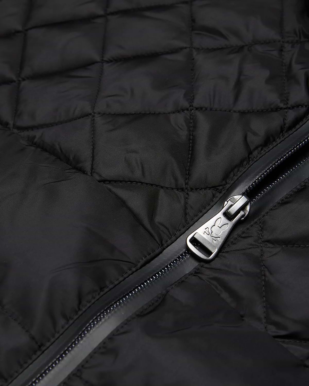 Mens Emerik Puffer Jacket in black quilted nylon, featuring a full-zip closure with a metallic Psycho Bunny skull logo embossed on the zipper pull.