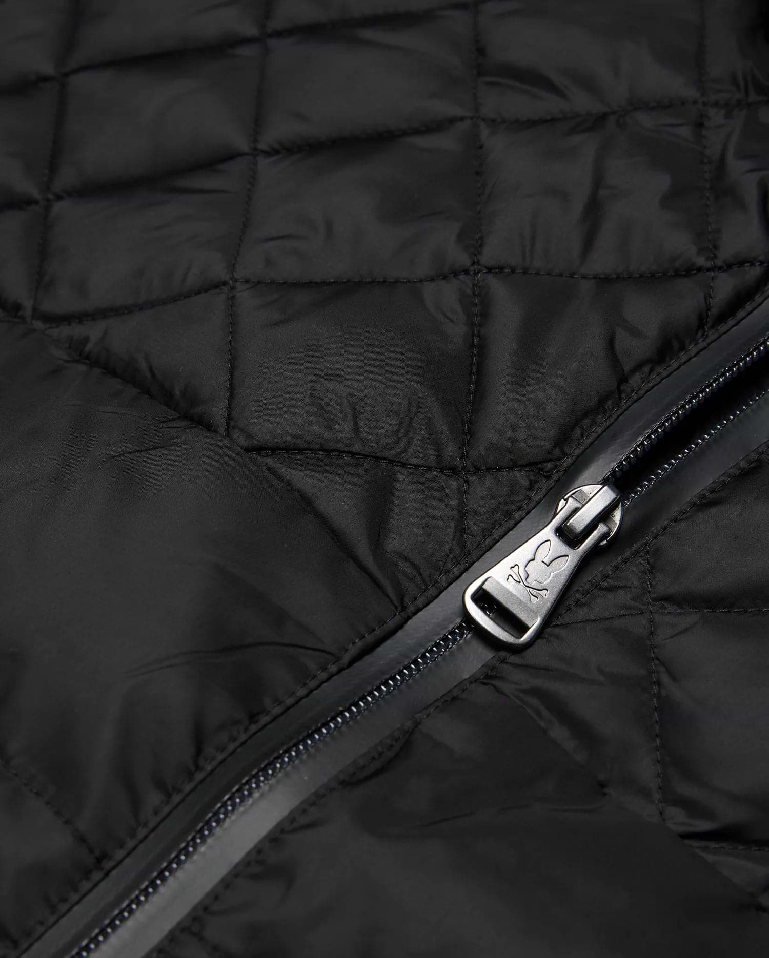 Mens Emerik Puffer Jacket in black quilted nylon, featuring a full-zip closure with a metallic Psycho Bunny skull logo embossed on the zipper pull.