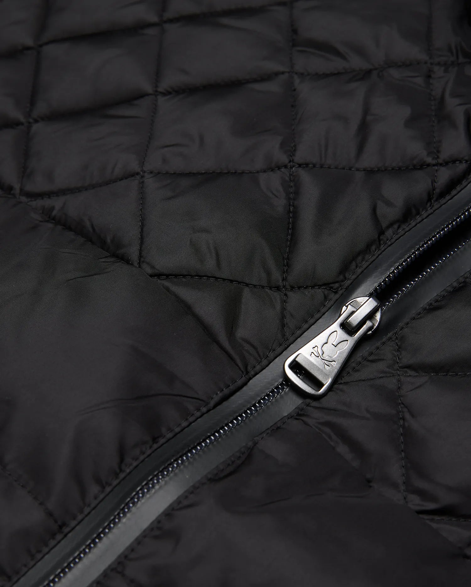 Mens Emerik Puffer Jacket in black quilted nylon, featuring a full-zip closure with a metallic Psycho Bunny skull logo embossed on the zipper pull.