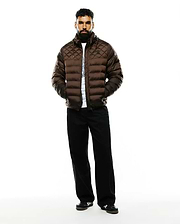 Mens Emerik Hooded Puffer Jacket in rich brown, featuring a diamond-quilted upper, horizontal baffles, a classic fit, and a subtle black Psycho Bunny skull logo on the left chest.