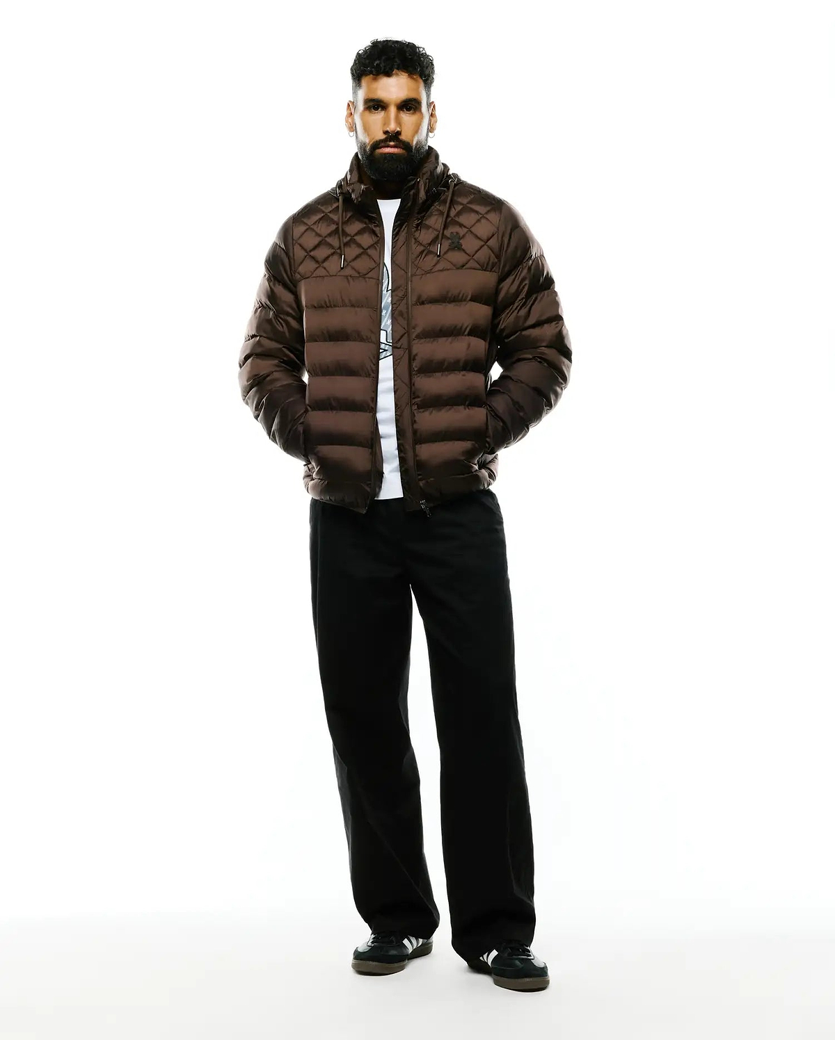 Mens Emerik Hooded Puffer Jacket in rich brown, featuring a diamond-quilted upper, horizontal baffles, a classic fit, and a subtle black Psycho Bunny skull logo on the left chest.