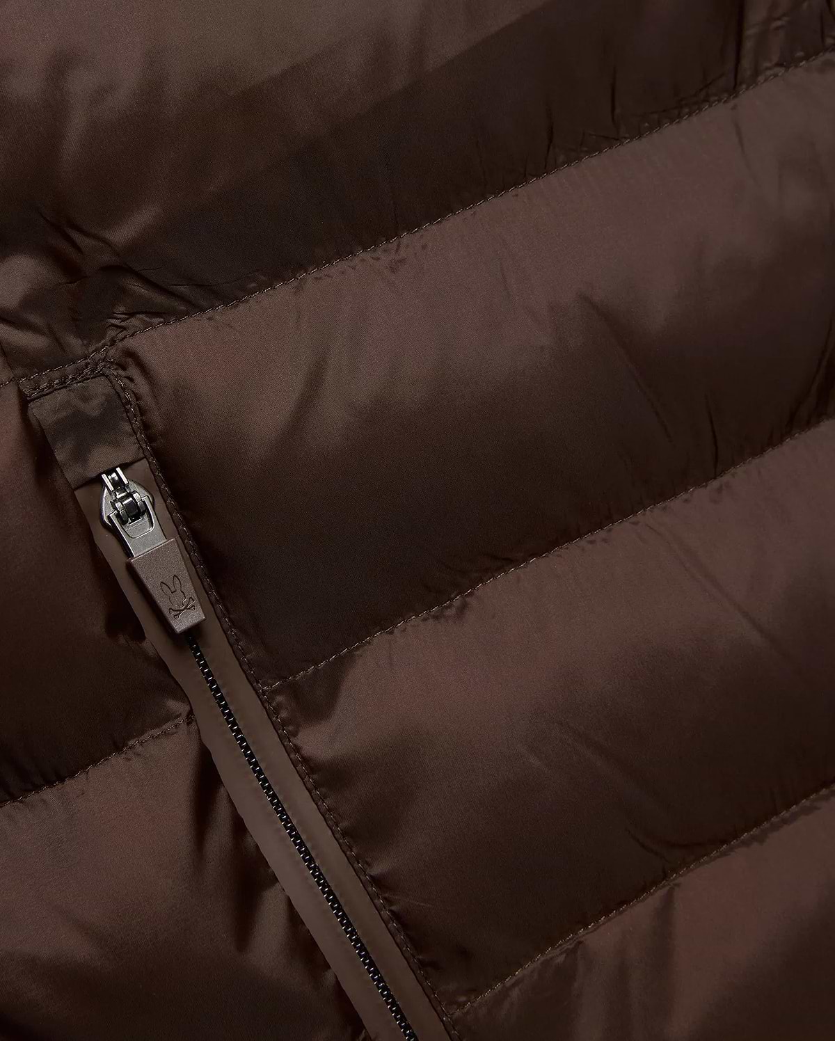 Mens Emerik Puffer Jacket in rich brown, crafted from smooth, quilted nylon. Features horizontal puffer channels and a dark grey zipper with a small Psycho Bunny skull logo pull.