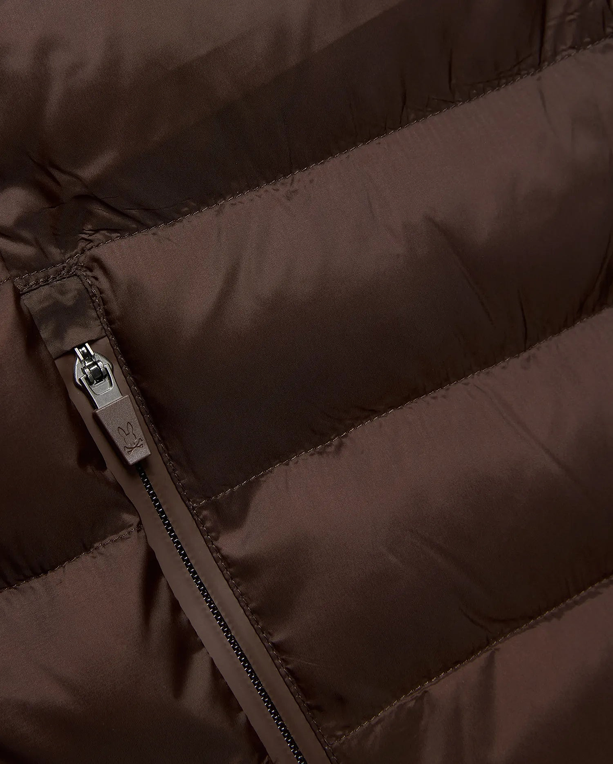 Mens Emerik Puffer Jacket in rich brown, crafted from smooth, quilted nylon. Features horizontal puffer channels and a dark grey zipper with a small Psycho Bunny skull logo pull.
