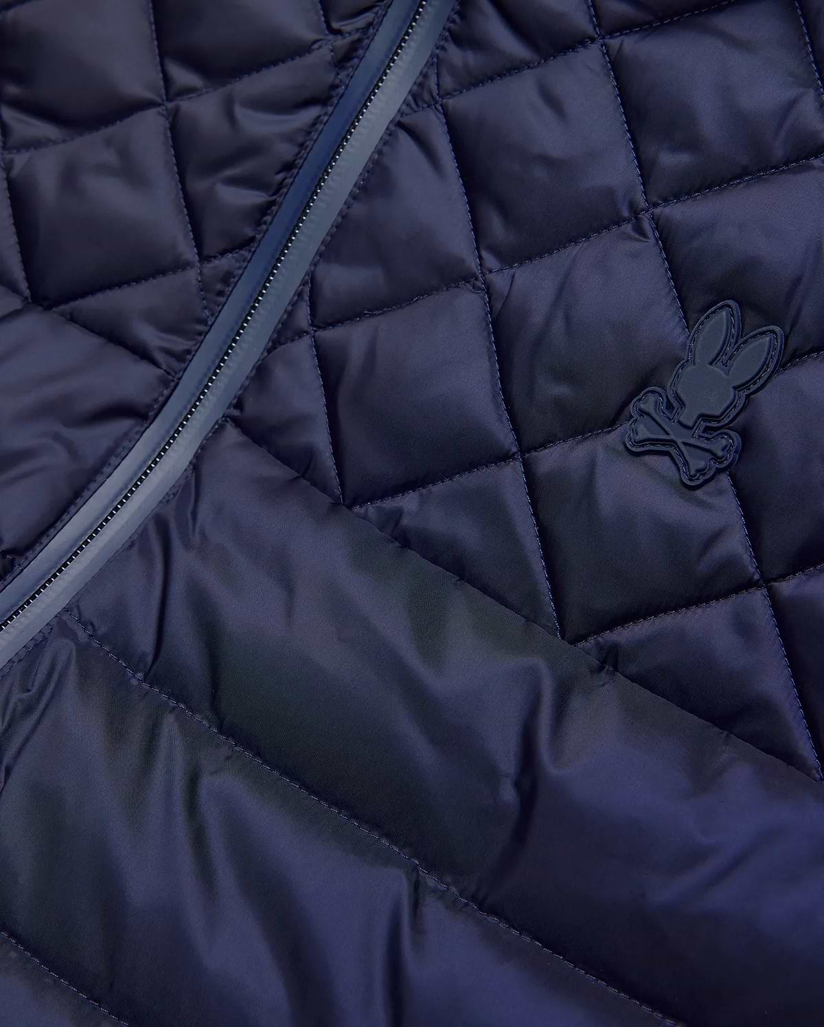 Mens Emerik Puffer Vest in navy, featuring a diamond quilted pattern, full-zip closure with dark trim, and a small, matching navy rubberized Psycho Bunny skull logo on the chest.