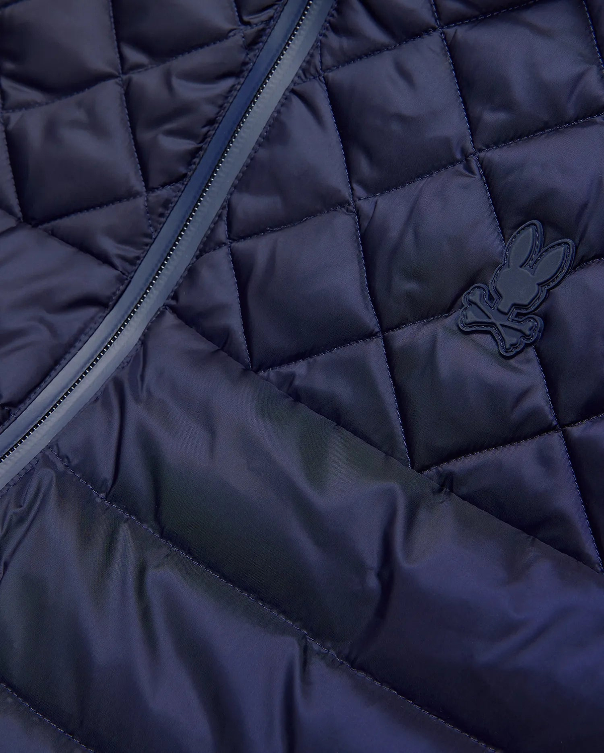 Mens Emerik Puffer Vest in navy, featuring a diamond quilted pattern, full-zip closure with dark trim, and a small, matching navy rubberized Psycho Bunny skull logo on the chest.
