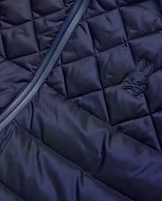 Mens Emerik Puffer Vest in navy, featuring a diamond quilted pattern, full-zip closure with dark trim, and a small, matching navy rubberized Psycho Bunny skull logo on the chest.