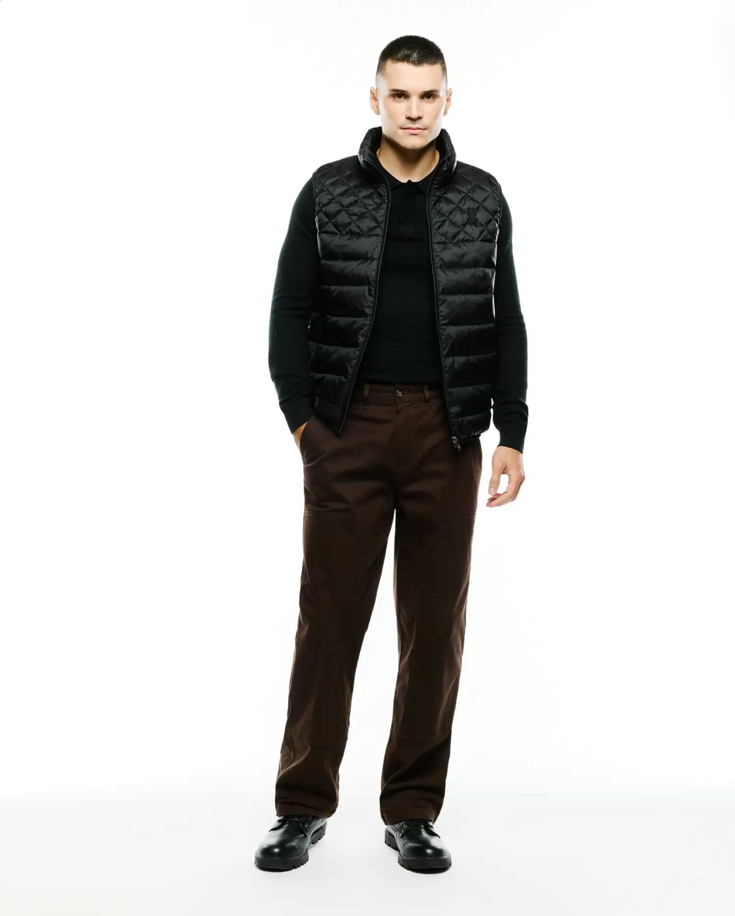 Mens Emerik Quilted Puffer Vest in black, featuring a classic fit, diamond quilting, full zip closure, stand collar, and a small embroidered Psycho Bunny skull logo on the left chest.