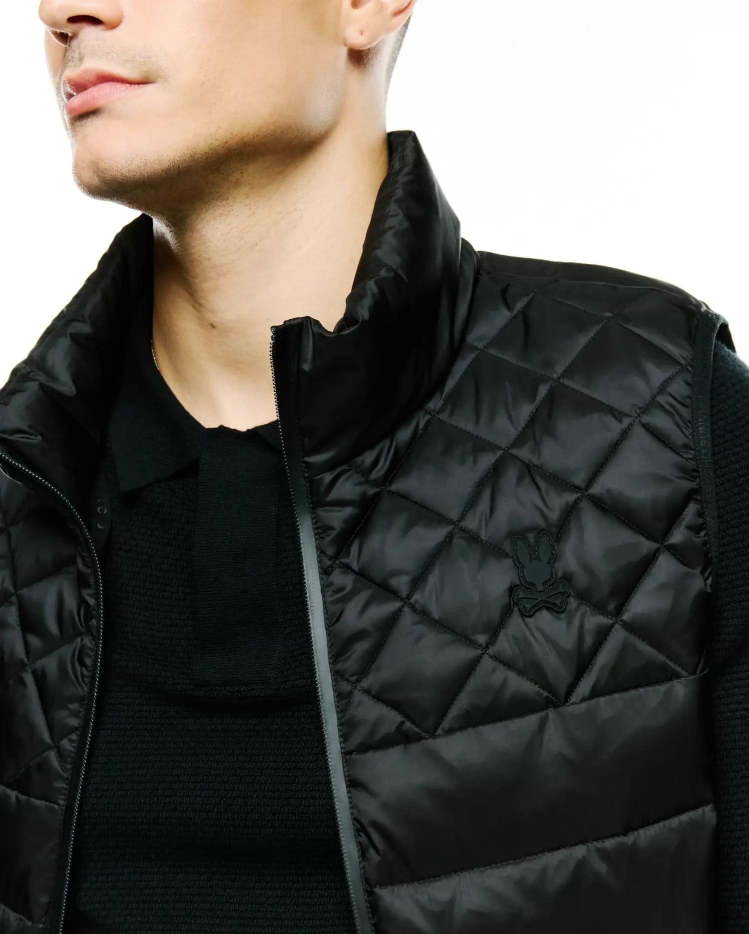 MENS EMERIK QUILTED PUFFER VEST, a black classic fit puffer vest featuring a diamond quilted pattern, stand-up collar, and a small tonal black Psycho Bunny skull logo on the left chest.
