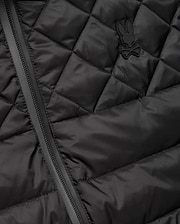 Mens Emerik Puffer Vest in black, featuring a quilted smooth nylon fabric, full-zip closure, and a small, tonal rubberized Psycho Bunny skull logo on the left chest.