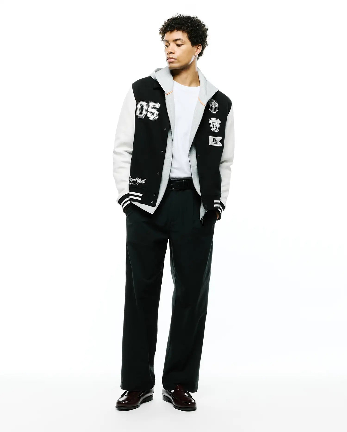 Mens Reilly Knit Coach Jacket: Black and white varsity style jacket with a layered grey hood, featuring a large 05 patch, embroidered Psycho Bunny skull, and New York script. (4)