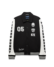Mens Reilly Knit Coach Jacket, black with white sleeves, features embroidered 05, New York text, multiple Psycho Bunny skull logo patches, and vertical PSYCHO BUNNY text on sleeves, with striped cuffs and hem. (5)