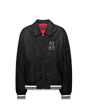 Mens Nathaniel Satin Coach Jacket, black with red lining, featuring a large white embroidered Psycho Bunny skull logo on the chest, white striped ribbed cuffs and hem, and a zippered sleeve pocket. (5)