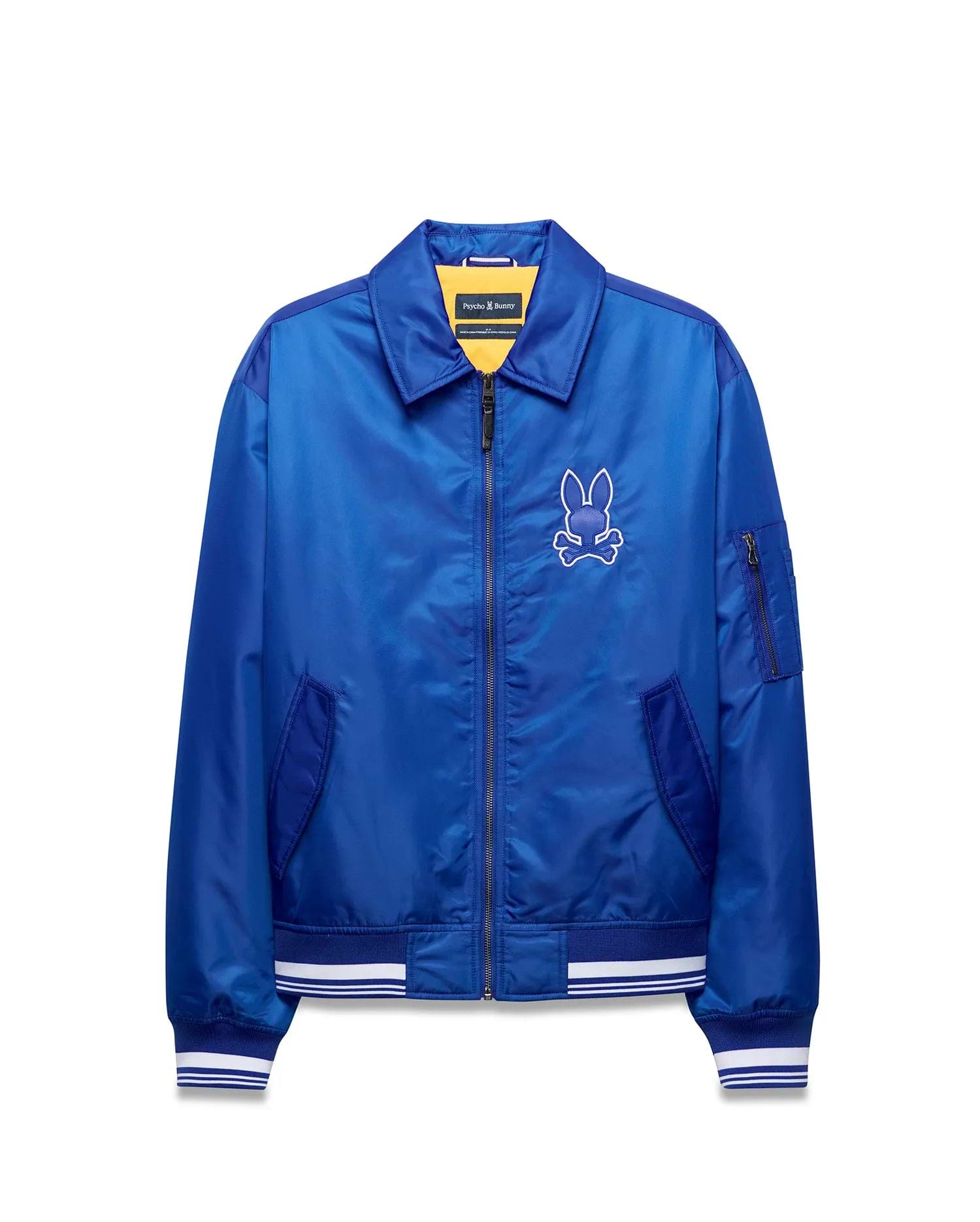 Mens Nathaniel Satin Coach Jacket, royal blue satin, full-zip, ribbed cuffs/hem with white stripes, zippered sleeve pocket, and large white embroidered Psycho Bunny skull logo on left chest. (6)