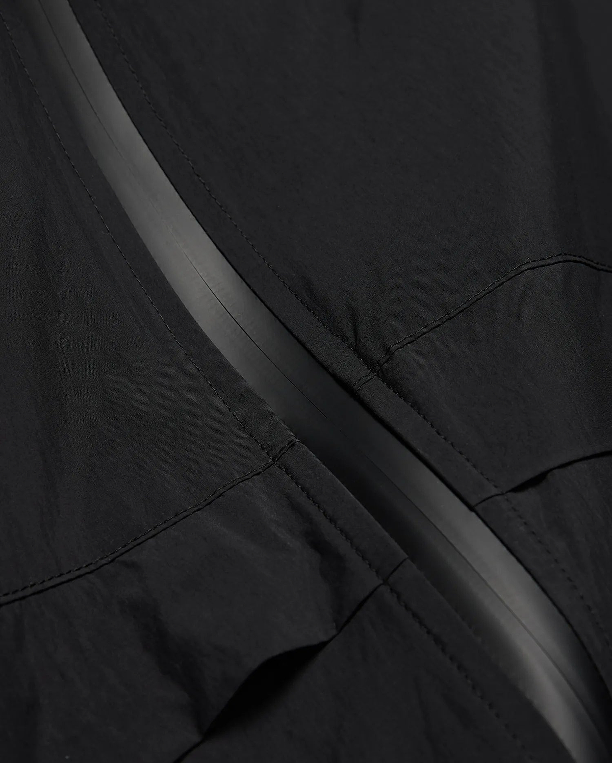 MENS JAVIER WINDBREAKER JACKET in black, featuring a subtle dark grey central zipper strip and visible panel stitching on lightweight, crinkled fabric. (6)