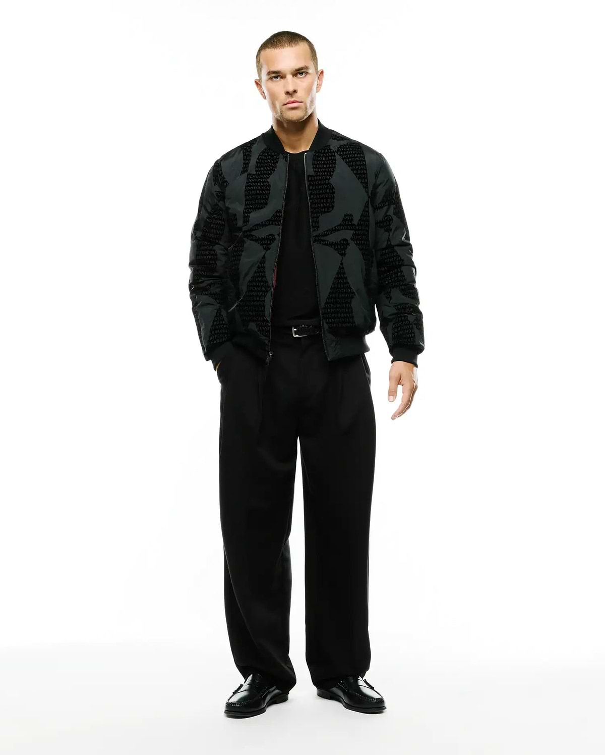 Angus Reversible Bomber in dark grey with a subtle all-over repeating PSYCHO BUNNY text pattern, featuring a classic fit, full zip, and ribbed cuffs and hem. (4)