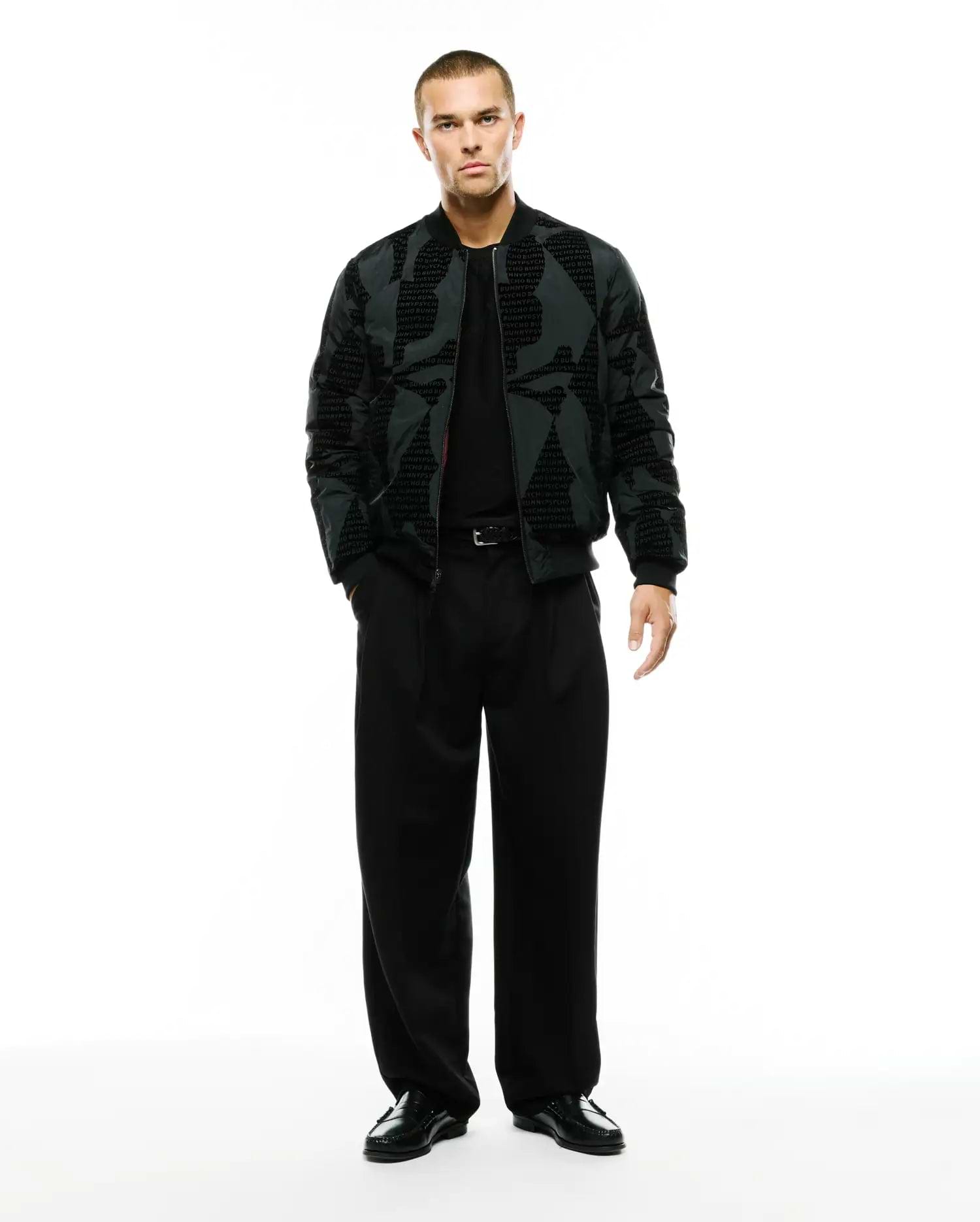 Angus Reversible Bomber in dark grey with a subtle all-over repeating PSYCHO BUNNY text pattern, featuring a classic fit, full zip, and ribbed cuffs and hem. (4)
