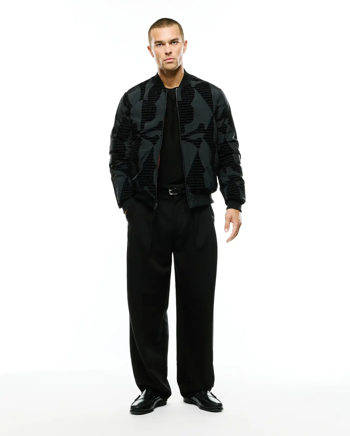 Angus Reversible Bomber in dark grey with a subtle all-over repeating PSYCHO BUNNY text pattern, featuring a classic fit, full zip, and ribbed cuffs and hem. (4)