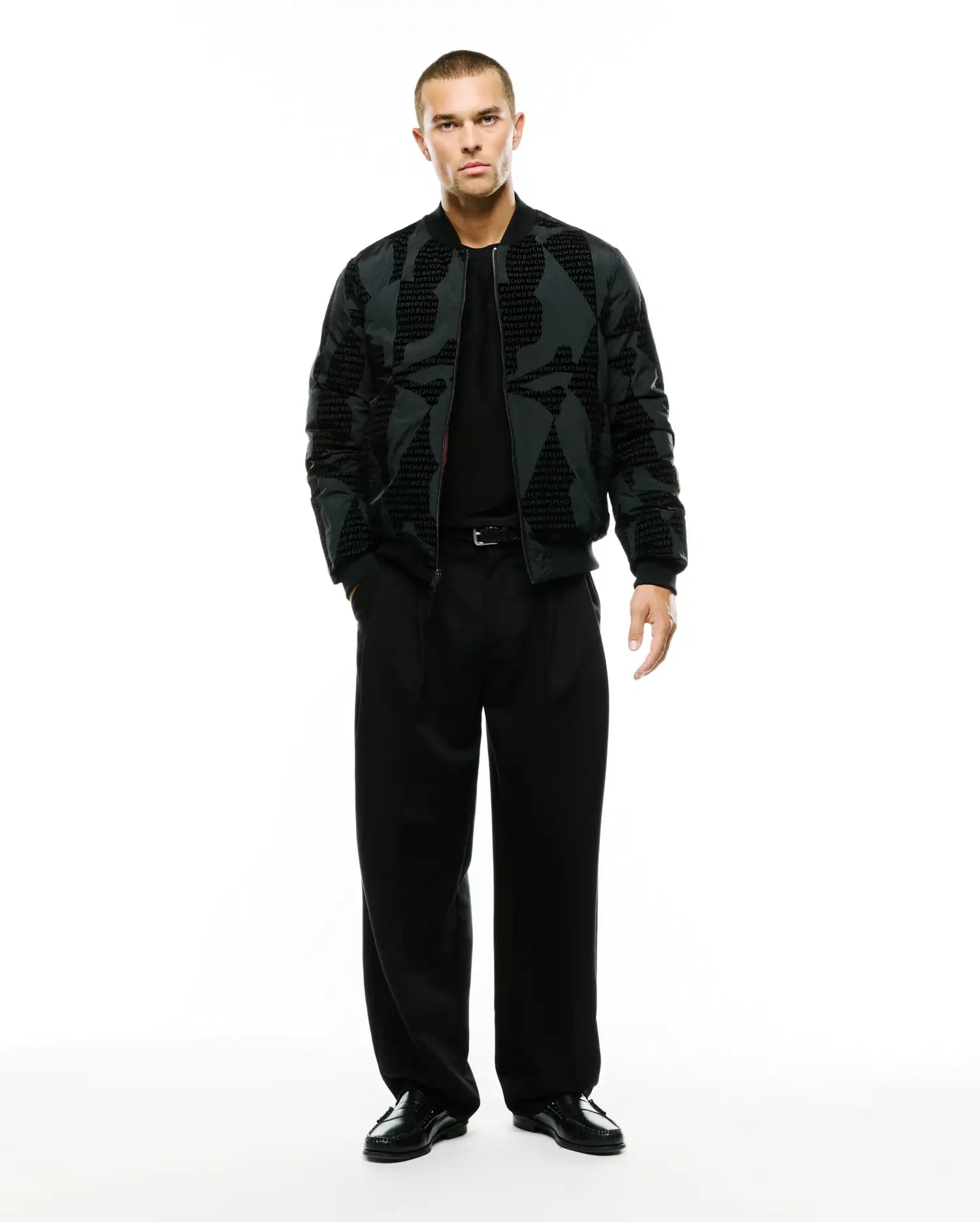 Angus Reversible Bomber in dark grey with a subtle all-over repeating PSYCHO BUNNY text pattern, featuring a classic fit, full zip, and ribbed cuffs and hem. (4)