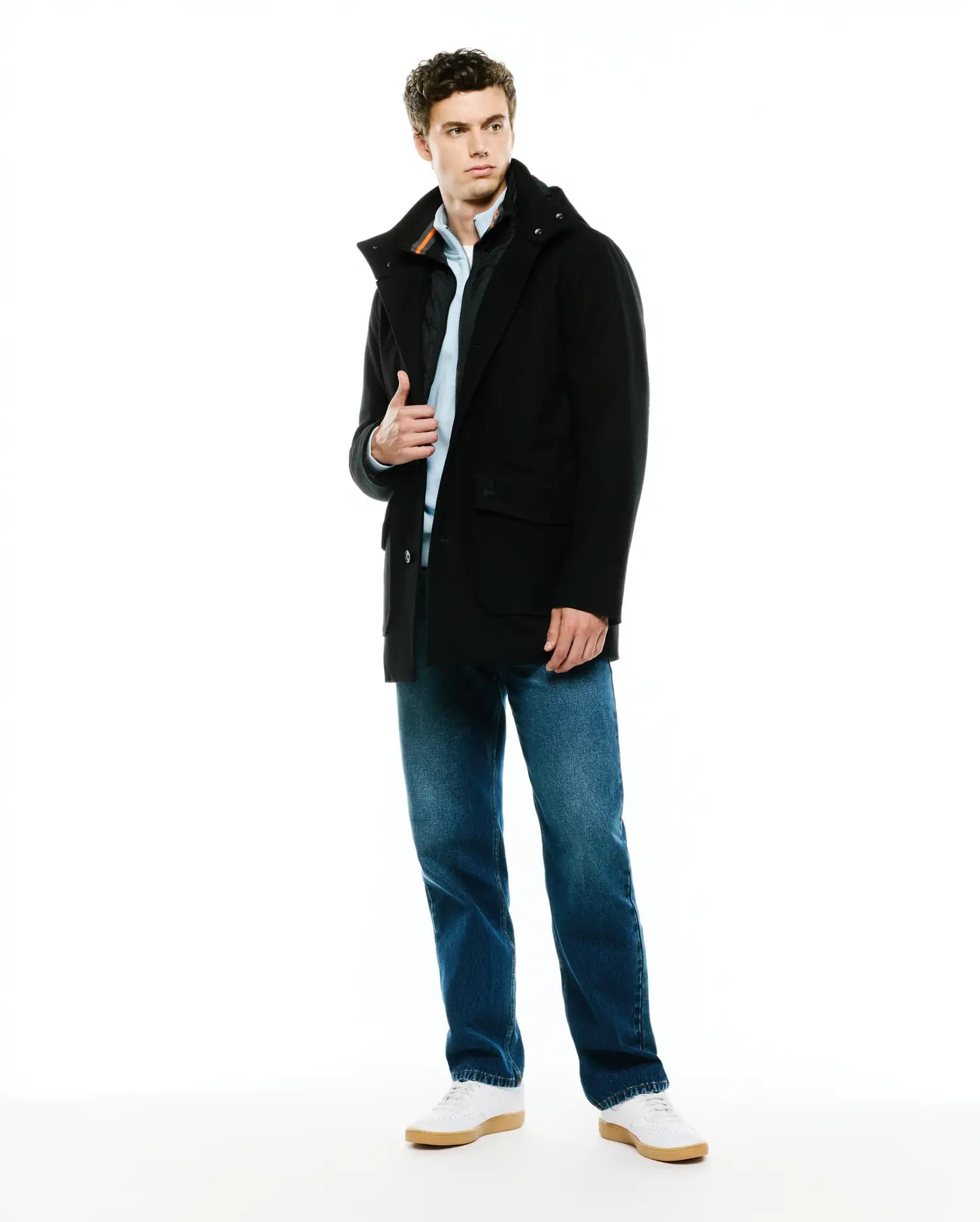 Mens Luther Wool Blend Coat, a black classic fit coat with a high collar, button closure, flap pockets, and a small embroidered Psycho Bunny skull logo on the left chest, featuring an orange accent stripe on the inner collar.