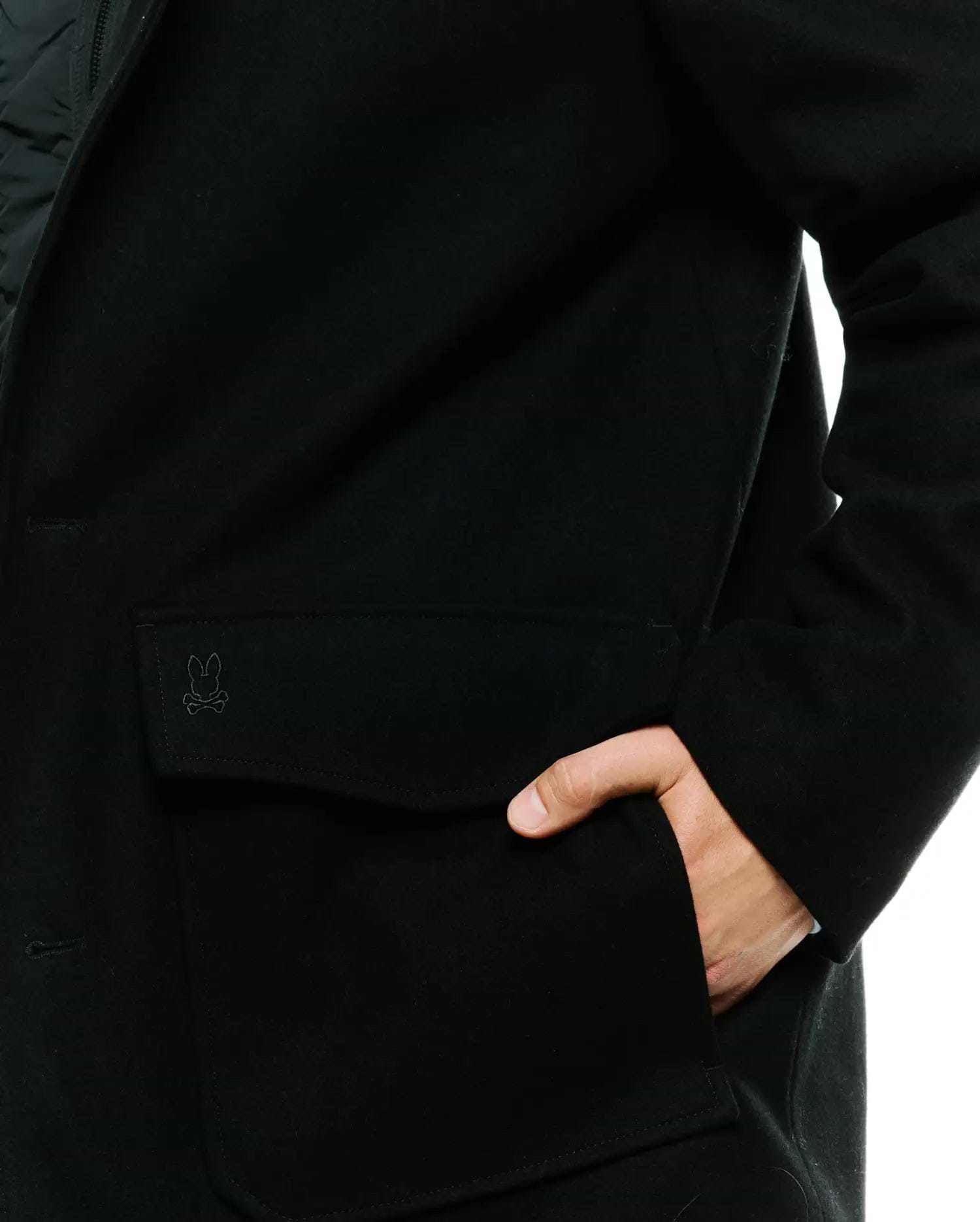 Black Mens Luther Wool Blend Coat with a classic fit, featuring a tonal embroidered Psycho Bunny skull logo on the flap pocket and a smooth wool blend texture.