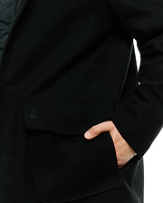 Black Mens Luther Wool Blend Coat with a classic fit, featuring a tonal embroidered Psycho Bunny skull logo on the flap pocket and a smooth wool blend texture.