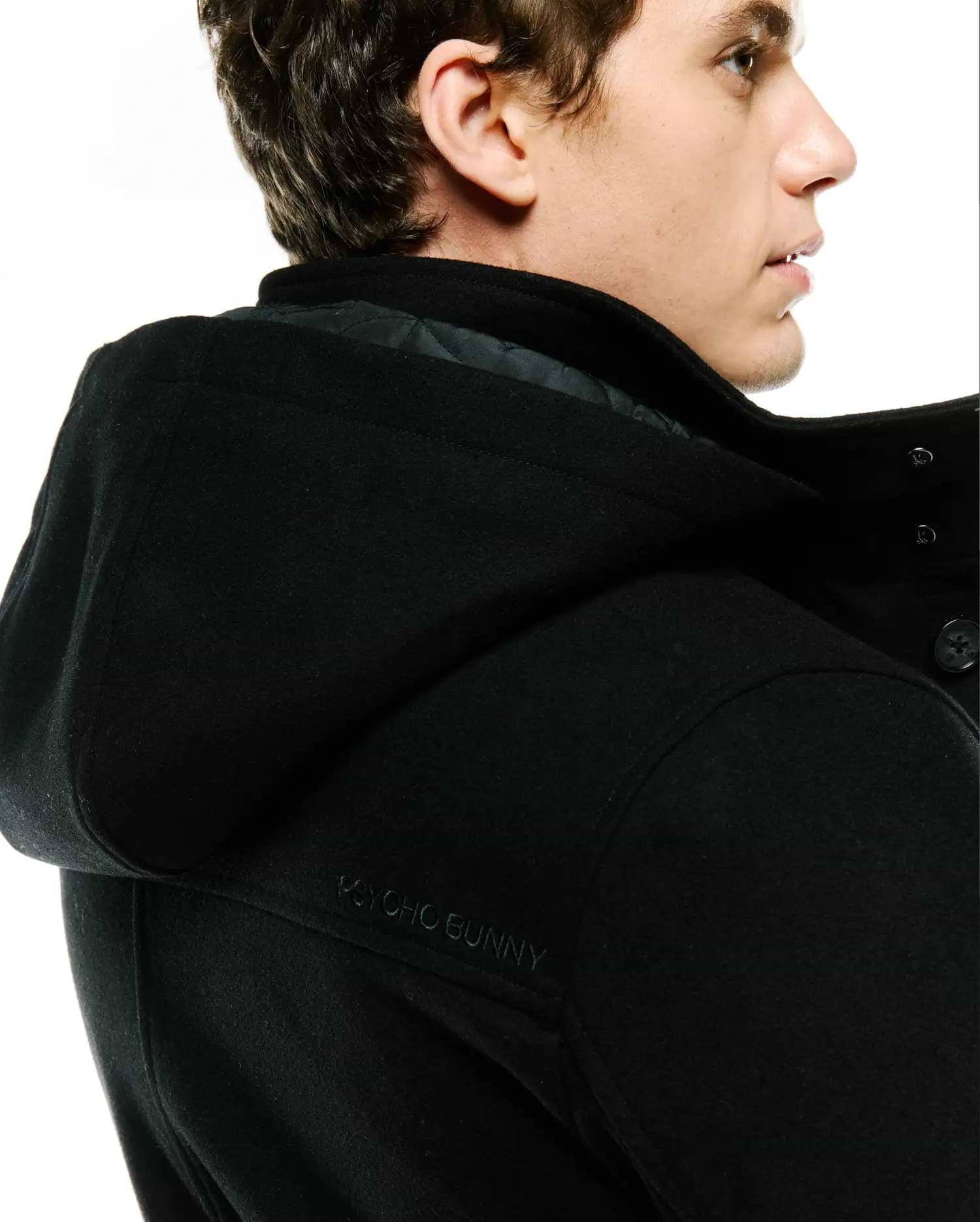 Black Mens Luther Wool Blend Coat, classic fit, featuring a hood with subtle tone-on-tone embroidered Psycho Bunny text on the back, and a quilted inner lining.