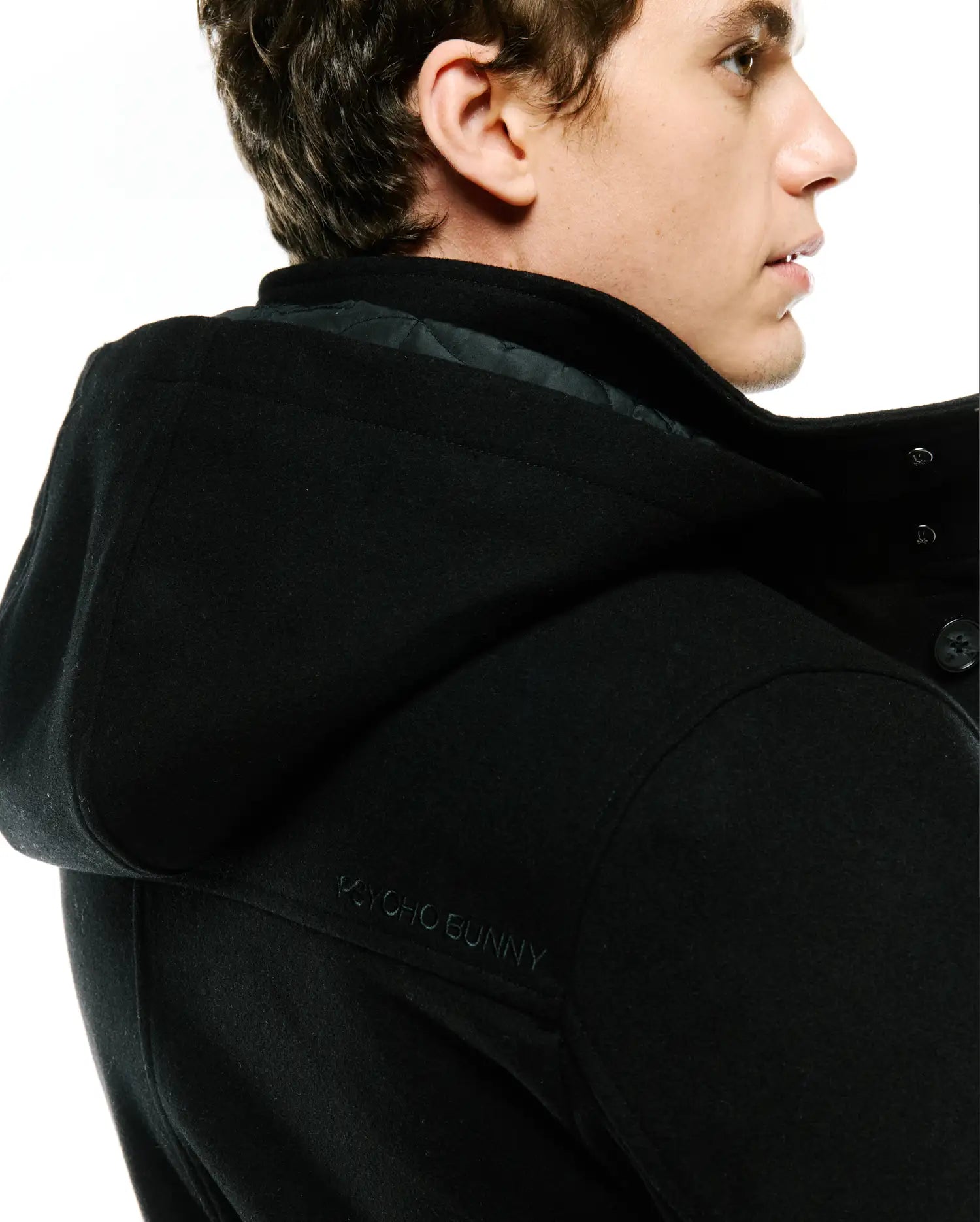 Black Mens Luther Wool Blend Coat, classic fit, featuring a hood with subtle tone-on-tone embroidered Psycho Bunny text on the back, and a quilted inner lining.