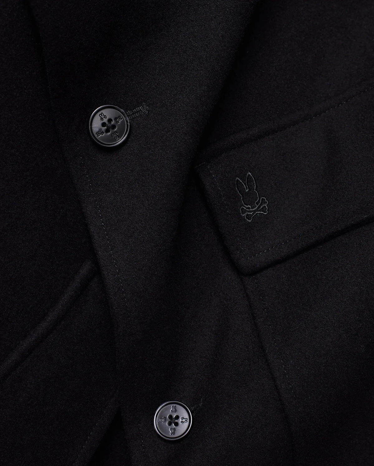 Mens Luther Wool Blend Coat, black, crafted from a smooth wool blend, featuring a tonal embroidered Psycho Bunny skull logo on the chest pocket flap and custom logo buttons.