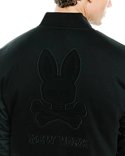 Mens Joaquin Mix Media Reversible Bomber in black, featuring a large tonal embroidered Psycho Bunny skull logo and NEW YORK text on the back, with contrasting quilted sleeves.