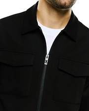 Men's Wayde Twill Overshirt in black, featuring a classic collar, full-zip front with a silver Psycho Bunny skull logo zipper pull, and two chest flap pockets, crafted from textured twill fabric for a relaxed fit. (2)