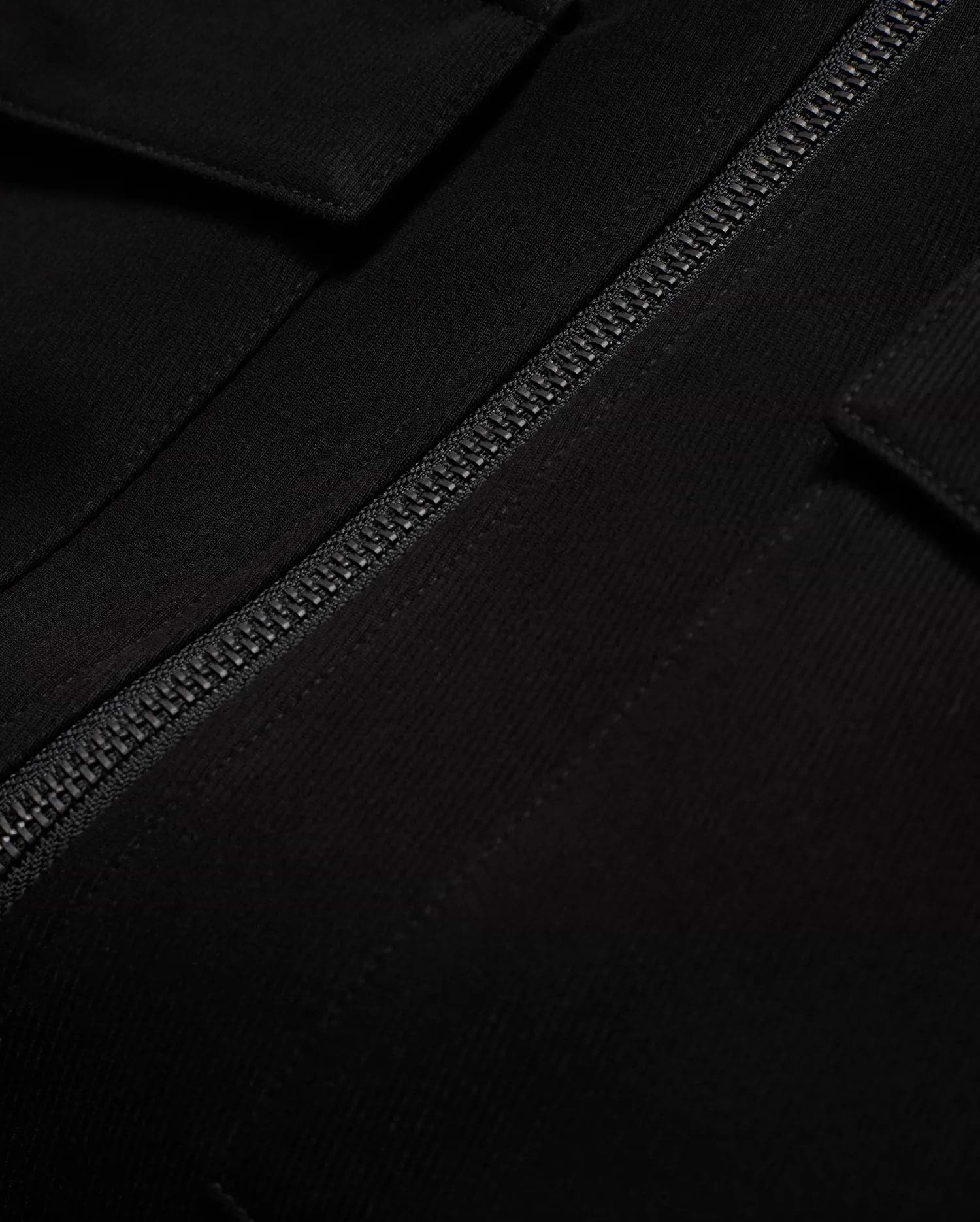 Men's Wayde Twill Overshirt, a premium black twill overshirt with a relaxed fit, featuring a prominent black zipper and a subtle flap pocket detail. (6)