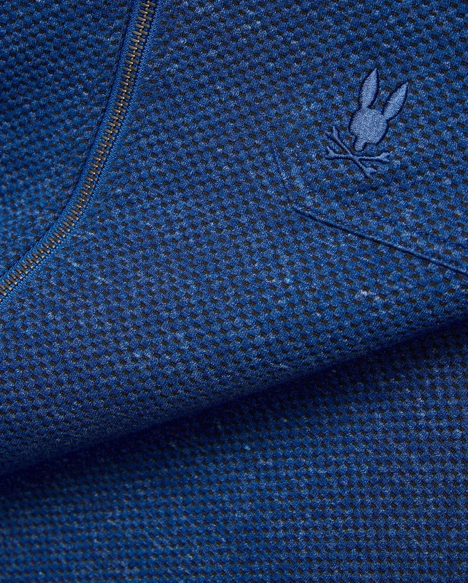 Mens Marc Textured Overshirt in deep blue heathered knit fabric with black flecks, featuring a dark metallic zipper and a small embroidered blue Psycho Bunny skull logo on the chest. (7)