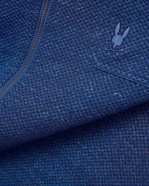 Mens Marc Textured Overshirt in deep blue heathered knit fabric with black flecks, featuring a dark metallic zipper and a small embroidered blue Psycho Bunny skull logo on the chest. (7)