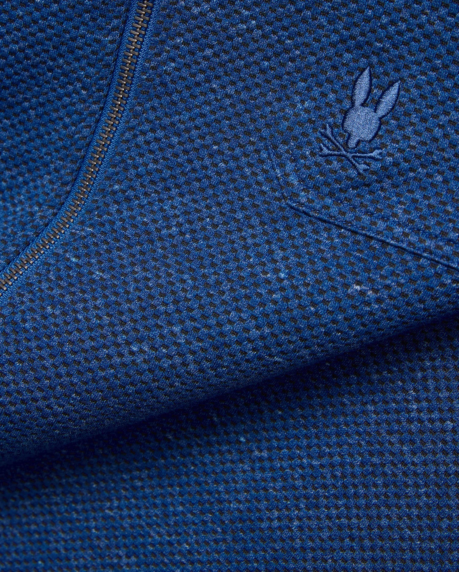 Mens Marc Textured Overshirt in deep blue heathered knit fabric with black flecks, featuring a dark metallic zipper and a small embroidered blue Psycho Bunny skull logo on the chest. (7)