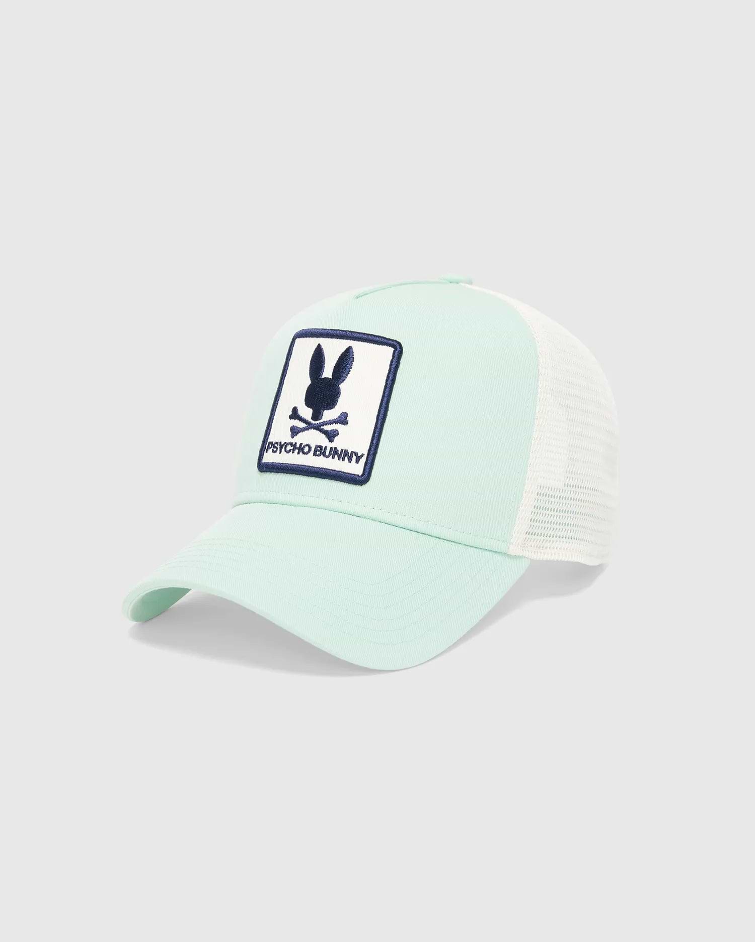 Mens Adamo Trucker Cap in mint green with a white mesh back. Features a large, embroidered navy blue and white Psycho Bunny skull logo patch on the front. (3)